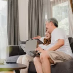 asian-elderly-couple-using-tablet-virtual-reality-simulator-playing-games-living-room-couple-feeling-happy-using-time-together-lying-sofa-home-lifestyle-senior-family-home-concept